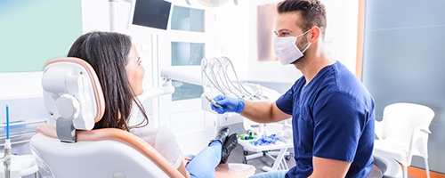 Dentist talking to patient at routine appointment