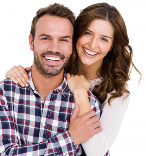 a couple smiling and hugging each other
