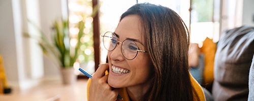 Closeup of woman smiling while working