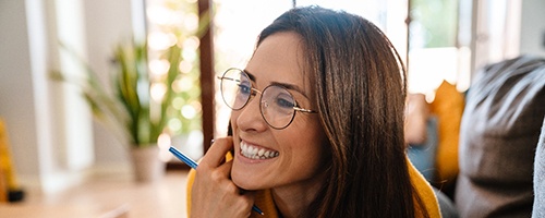 Closeup of woman smiling while working