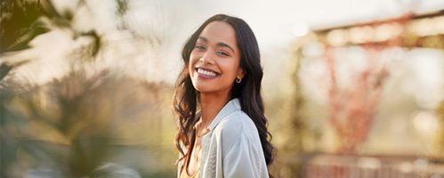 Woman smiling after undergoing dental bonding 