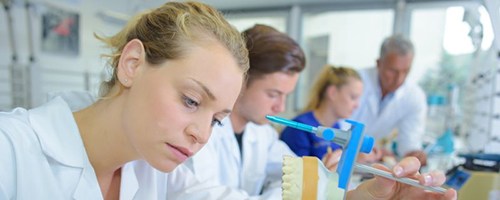 Dental lab technician working on dentures