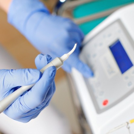 Dentist holding a soft tissue laser