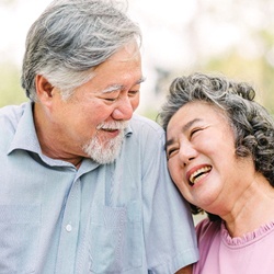 Couple smiles with dental implants in Mesquite