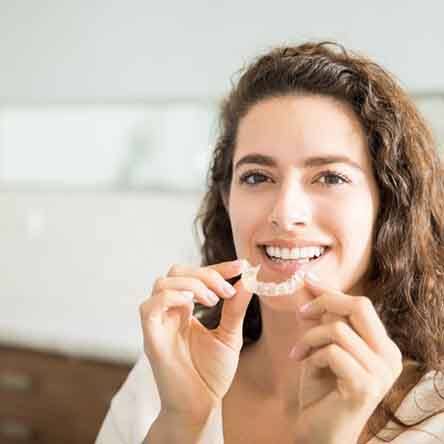 Woman smiling while wearing Invisalign in Mesquite