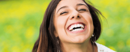 Woman laughing outdoors