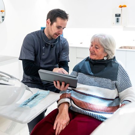Dentist and senior patient talking during consultation