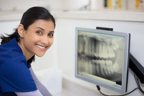 Team member using dental implant technology in Mesquite
