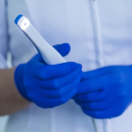 Dental assistant taking intraoral photos of patient's smile