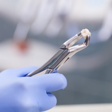 Woman in dental chair giving thumbs up