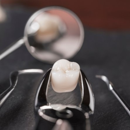 Woman in dental chair giving thumbs up