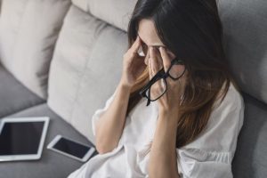 stressed person sitting on their couch 