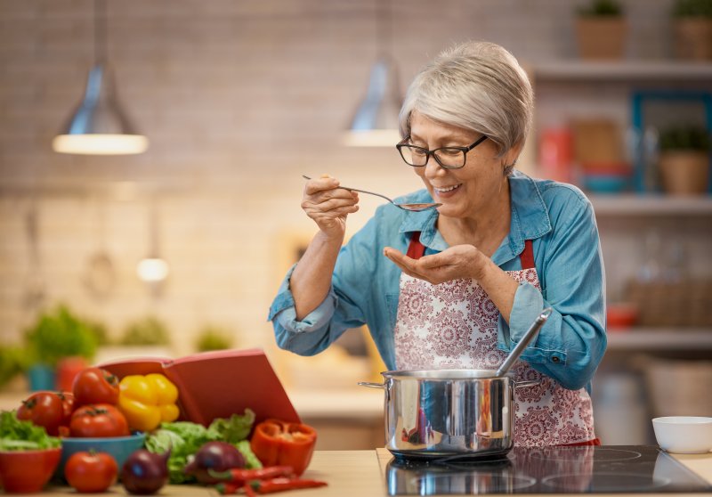 woman fixing soup after All-On-4 surgery