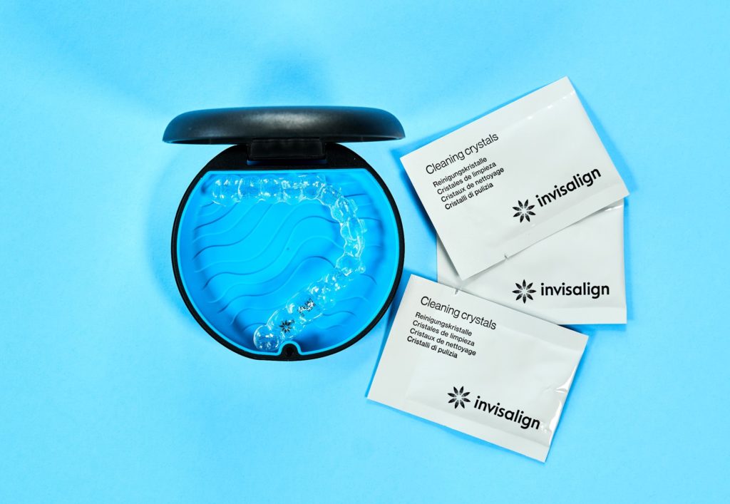 Invisalign cleaning crystal packets next to case