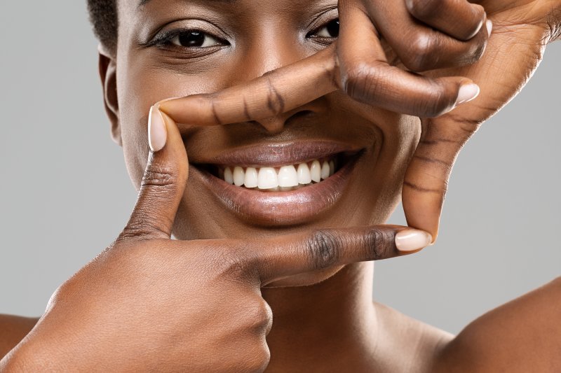 A woman showing off her white teeth after treatment